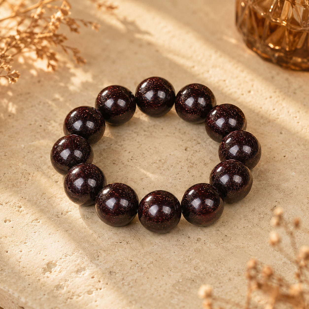 Natural red sandalwood bracelet with dark reddish-brown polished wood beads on a light background